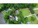An aerial view reveals a sprawling property with lush greenery, a pond, and multiple structures at 206 Chaussee Blvd, Summerville, SC 29483