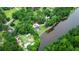 Aerial shot of a property with mature trees, circle driveway, lake and fountain and green grass at 206 Chaussee Blvd, Summerville, SC 29483