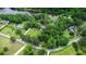Aerial view of a large estate with manicured lawns, mature trees, and waterfront views at 206 Chaussee Blvd, Summerville, SC 29483