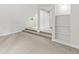 Bright, carpeted attic featuring stairs to landing and built in bookshelves at 206 Chaussee Blvd, Summerville, SC 29483