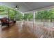 Relaxing covered back porch with brown wicker sofa, ceiling fan and a view of the backyard at 206 Chaussee Blvd, Summerville, SC 29483
