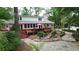 Backyard view with a stone path, landscaped garden, and deck, creating a relaxing outdoor living area at 206 Chaussee Blvd, Summerville, SC 29483
