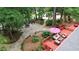 Lush backyard featuring stone path, landscaping, fire pit, and back deck with seating at 206 Chaussee Blvd, Summerville, SC 29483
