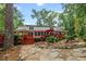 Picturesque backyard view with a stone pathway, waterfall feature, and lush landscaping, creating a tranquil retreat at 206 Chaussee Blvd, Summerville, SC 29483