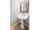 Bathroom features a charming pedestal sink with decorative mirror and neutral tile flooring at 206 Chaussee Blvd, Summerville, SC 29483
