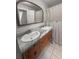 Bathroom featuring a double sink vanity with gray marble countertops and wooden cabinets at 206 Chaussee Blvd, Summerville, SC 29483