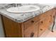 Bathroom vanity with gray and white marble countertops and dark wooden cabinets at 206 Chaussee Blvd, Summerville, SC 29483
