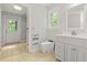 Well-lit bathroom with a modern toilet, walk-in closet, and a sleek vanity at 206 Chaussee Blvd, Summerville, SC 29483