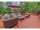 Inviting outdoor deck area with stylish patio furniture and umbrella for relaxing and entertaining at 206 Chaussee Blvd, Summerville, SC 29483