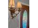 Elegant entryway featuring a decorative wall sconce and a beautiful wood door with leaded glass at 206 Chaussee Blvd, Summerville, SC 29483