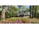 Inviting exterior of home surrounded by lush landscaping, showcasing its serene setting and charming curb appeal at 206 Chaussee Blvd, Summerville, SC 29483