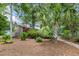 Exterior elevation showing a two-story home with a landscaped yard and mature trees at 206 Chaussee Blvd, Summerville, SC 29483