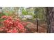 Picturesque home with beautiful landscaping and a black fence, blending elegance with natural charm for an inviting curb appeal at 206 Chaussee Blvd, Summerville, SC 29483