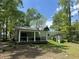 Charming single-story home with a covered porch, storage shed, and a well-manicured lawn at 206 Chaussee Blvd, Summerville, SC 29483