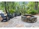 Comfortable backyard featuring a stone fire pit area with seating perfect for outdoor relaxation at 206 Chaussee Blvd, Summerville, SC 29483