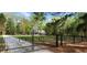 View of the front gate leading to a house, showcasing its secure entrance and the lush greenery of the property at 206 Chaussee Blvd, Summerville, SC 29483