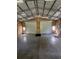 Spacious garage interior, showcasing two large roll-up doors, windows, and a clean concrete floor at 206 Chaussee Blvd, Summerville, SC 29483