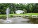 The garage is set on a lush green lawn, framed by trees and a decorative water feature at 206 Chaussee Blvd, Summerville, SC 29483