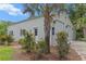 Large detached garage with red rose bushes flanking doors and windows at 206 Chaussee Blvd, Summerville, SC 29483