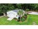A modern garage surrounded by manicured landscaping, palm trees, and a circular driveway at 206 Chaussee Blvd, Summerville, SC 29483