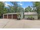 Detached garages with stained wood doors providing ample parking and storage space at 206 Chaussee Blvd, Summerville, SC 29483