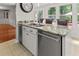 Kitchen island featuring granite countertops, stainless steel dishwasher, and a large stainless steel sink at 206 Chaussee Blvd, Summerville, SC 29483