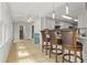 Kitchenette with bar seating, open layout, and seamless transition to sunroom at 206 Chaussee Blvd, Summerville, SC 29483