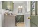 Well-equipped laundry room with modern washer and dryer, ample storage, and natural light at 206 Chaussee Blvd, Summerville, SC 29483
