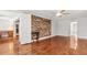 Spacious living room with hardwood floors, a brick accent wall and a bright interior at 206 Chaussee Blvd, Summerville, SC 29483