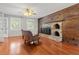 Inviting living room with a rustic fireplace, wood accents, and gleaming hardwood floors at 206 Chaussee Blvd, Summerville, SC 29483
