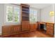 Home office featuring custom built-in wood shelving, a built-in desk, and hardwood floors at 206 Chaussee Blvd, Summerville, SC 29483