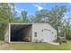 Large outbuilding with garage door and covered area perfect for equipment storage and a workshop space at 206 Chaussee Blvd, Summerville, SC 29483