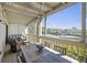 Relaxing screened-in balcony with tennis court view and comfortable seating, perfect for enjoying the outdoors at 2063 Long Bend Dr, Seabrook Island, SC 29455
