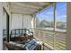 Screened-in balcony featuring cozy seating, neutral accents and lighting, and a view of the community at 2063 Long Bend Dr, Seabrook Island, SC 29455