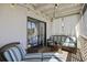 Screened-in balcony featuring cozy seating, neutral accents, and relaxing lighting at 2063 Long Bend Dr, Seabrook Island, SC 29455