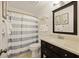 Bathroom with a striped shower curtain, framed mirror, and tile floors at 2063 Long Bend Dr, Seabrook Island, SC 29455