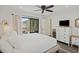Inviting bedroom with light walls, dark floors, and sliding glass doors to private balcony at 2063 Long Bend Dr, Seabrook Island, SC 29455