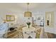 Bright dining area featuring a round table, decorative lighting, and an open view into the kitchen at 2063 Long Bend Dr, Seabrook Island, SC 29455