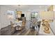 Cozy dining area with a round table, stylish chairs, and a view into the living room and outdoor balcony at 2063 Long Bend Dr, Seabrook Island, SC 29455