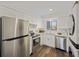 Modern kitchen featuring stainless steel appliances, white cabinetry, and an adjacent laundry setup at 2063 Long Bend Dr, Seabrook Island, SC 29455