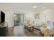 Bright living room with wood floors and a glass sliding door to outdoor patio at 2063 Long Bend Dr, Seabrook Island, SC 29455