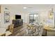 Comfortable living room featuring stylish seating, TV, ceiling fan and patio access at 2063 Long Bend Dr, Seabrook Island, SC 29455