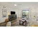 Cozy living room with ceiling fan, comfortable seating, and a sliding door to outdoor patio at 2063 Long Bend Dr, Seabrook Island, SC 29455