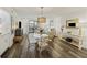 Bright living area with a dining space and outdoor view, featuring stylish decor and wood floors at 2063 Long Bend Dr, Seabrook Island, SC 29455