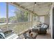 Cozy screened patio with comfortable seating and a view of the landscape at 2063 Long Bend Dr, Seabrook Island, SC 29455