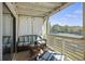 Inviting screened patio featuring wicker furniture and a view of the tennis courts at 2063 Long Bend Dr, Seabrook Island, SC 29455