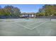 Full tennis court view behind black fence with bench and partial building view at 2063 Long Bend Dr, Seabrook Island, SC 29455