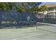 Tennis court behind black fence with Seabrook Island Racquet Club logo at 2063 Long Bend Dr, Seabrook Island, SC 29455