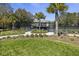Landscaped view of tennis courts behind fence with walking path and lawn at 2063 Long Bend Dr, Seabrook Island, SC 29455