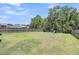 Fenced-in backyard with a playset, grass, and trees at 2109 Rowan Rd, Johns Island, SC 29455